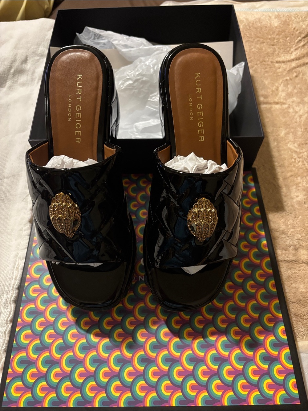 Kurt Geiger Black Patent Slide Mules with Gold Medallion